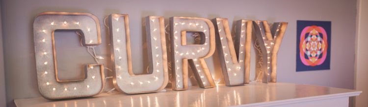Light-up sign that says Curvy 